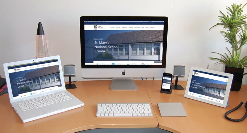 Responsiveness of St. Mary's National School's website shown across a Desktop, Laptop, Tablet, and Mobile Phone.