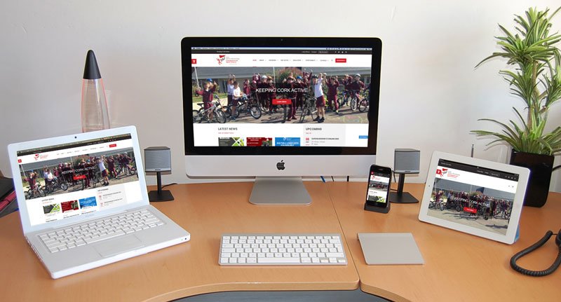 Responsiveness of Cork Sports Partnership's website shown across a Desktop, Laptop, Tablet, and Mobile Phone.