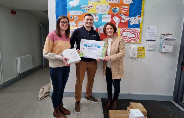 Bluescope's Ciarán Brogan holds a hand drawn picture from SMNS students.