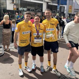 Three men pose in running gear at Great Limerick Run 2025.