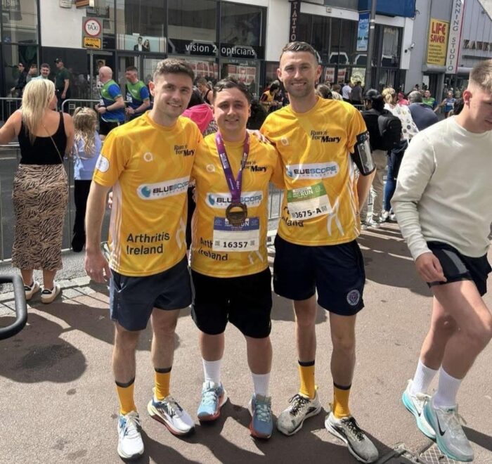 Three men pose in running gear at Great Limerick Run 2025.