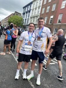 Two runners pose for picture with their medals for the Great Limerick Run.