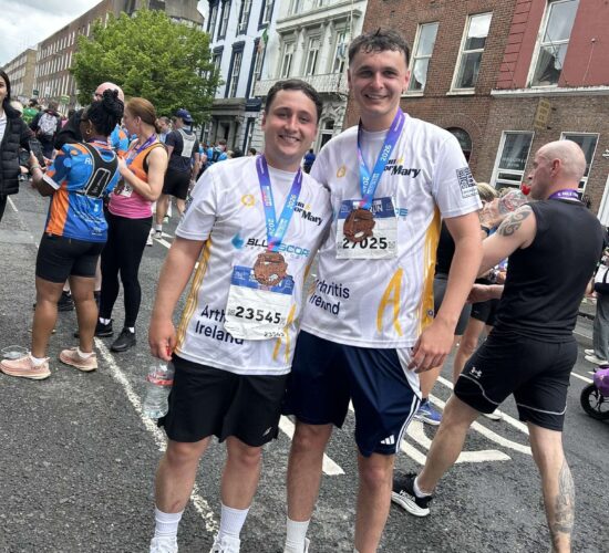 Two runners pose for picture with their medals for the Great Limerick Run.